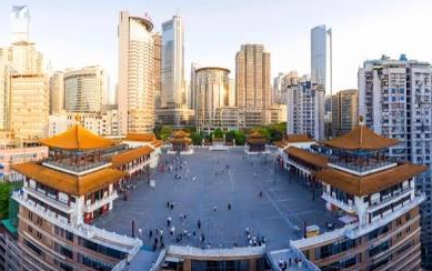 High-angle view of the massive open-air courtyard plaza at Kuixinglou showing modern skyscrapers and vertical layers in Chongqing