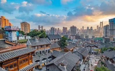 Traditional grey-brick tiled rooftops and courtyard buildings of Shibati traditional area against a sunset sky in Chongqing