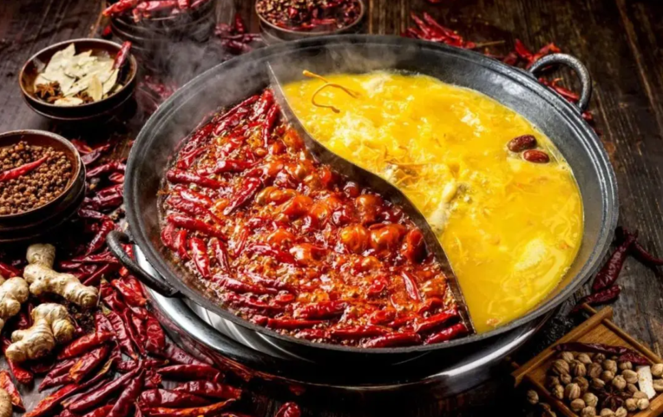 Chongqing hot pot with spicy and non-spicy broth and shared dishes