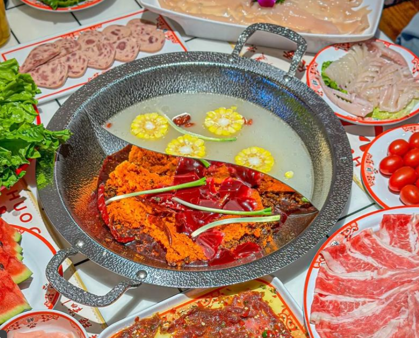 Chongqing hot pot with spicy and non-spicy broth and shared dishes