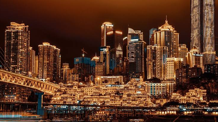 Stunning three-dimensional neon-lit cyberpunk skyline of Chongqing Yuzhong peninsula over the river at night
